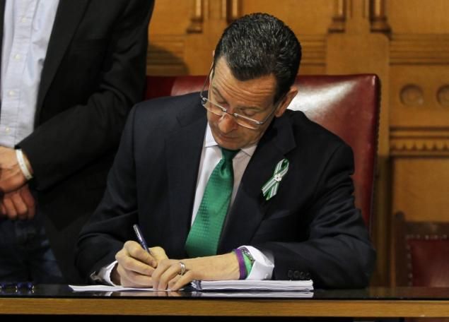 CT Gov. Dannel Malloy signs historic gun safetey bill on April 4, 2013. Photo by Jessica Rinaldi/EPA